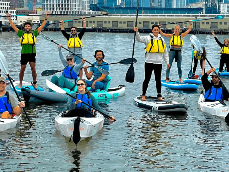 Kayakers paddling together on San Francisco Bay with bridge in background
