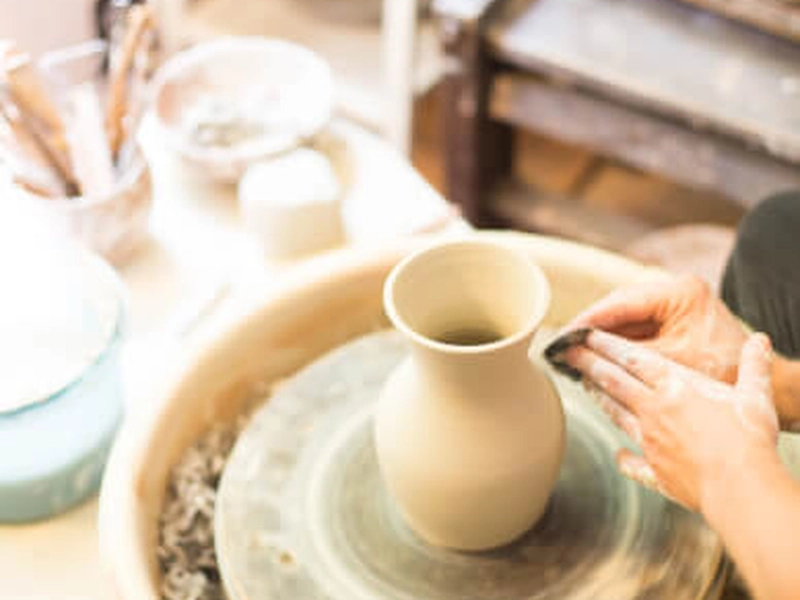 On-site pottery workshop with wheel throwing and hand-building for corporate team building.