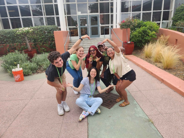 New York style pizza making team building - group tossing dough and adding toppings at your venue