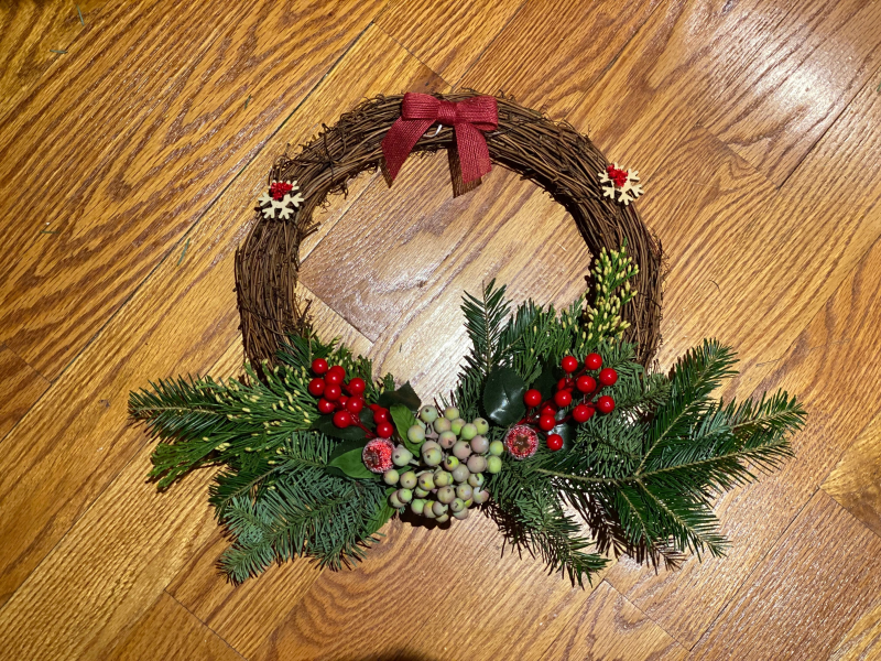 Group making seasonal wreaths with greenery